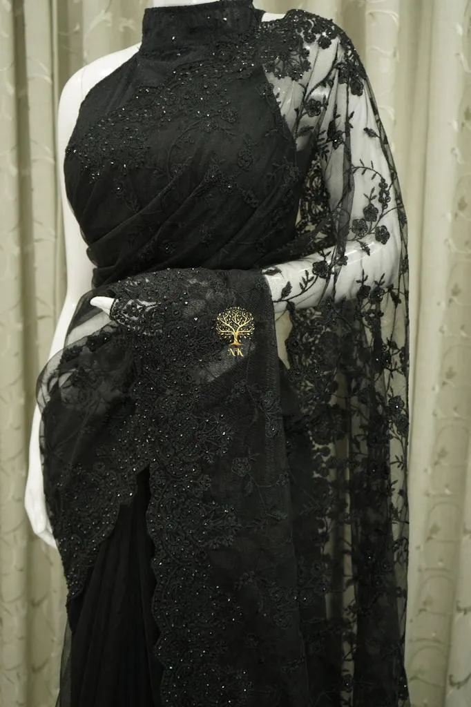 Designer black soft net saree with chikankari work highlighted by diamond work